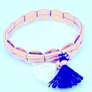 J Crew Gold Tone Metal Stretch Bracelet With A Black And White Tassels Sz 6 1/2”